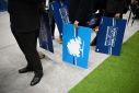 Delegates hold placards at the annual Conservative Party Conference in Manchester