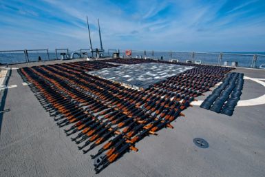 A handout photo released on December 22, 2021 by the US Defense Department shows AK-47 rifles and ammunition seized by the US navy from a fishing boat in the North Arabian Sea