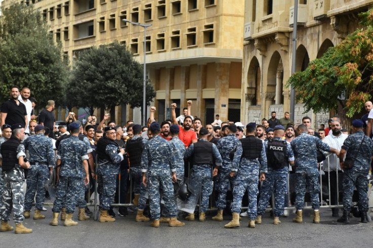 Police stop men from intercepting a march in support of liberties in Lebanon's capital Beirut