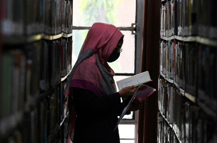 A Pakistani Ahmadi woman reads a book at a library in Rabwah