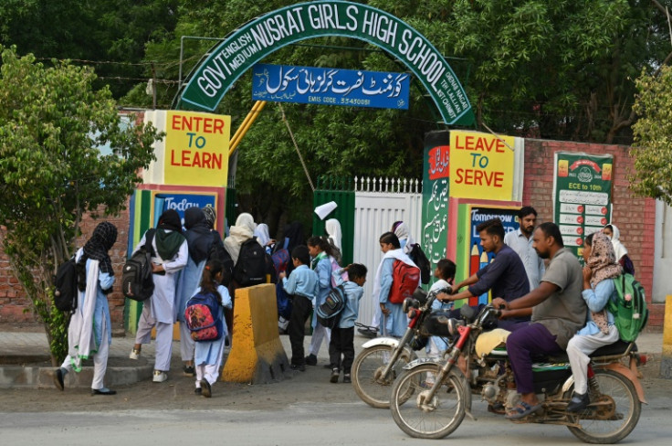 Children arrive at an english medium school in Rabwah