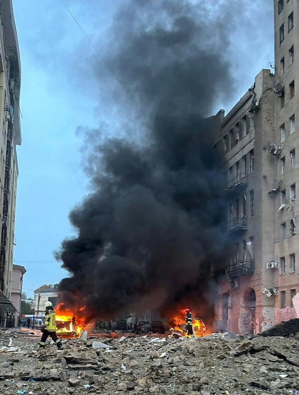 Rescuers seek to extinguish a fire after a Russian strike hit the centre of the Ukrainian city of Kharkiv on October 6, 2023