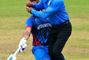 Afghanistan’s Gulbadin Naib (L) collides with the umpire