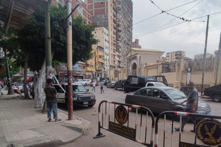 Egyptian police at the site where a policeman killed two Israeli tourists and their local guide in Alexandria