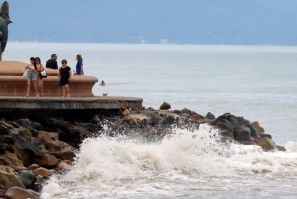 Tourists stroll along the seafront in the Mexican city of Puerto Vallarta hours before the expected arrival of Hurricane Lidia