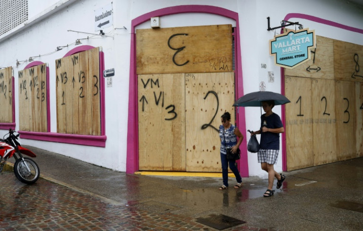 Shopkeepers in Mexico's beachside city of Puerto Vallarta boarded up windows before Hurricane Lidia made landfall