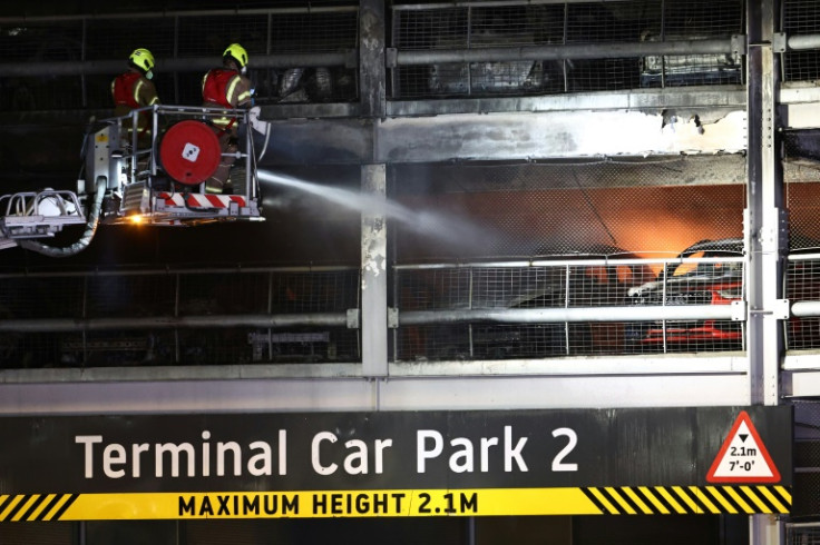 Firemen battle a fire at London's Luton Airport which caused a partial collapse of a parking structure