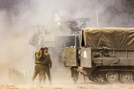 An Israeli army self-propelled howitzer fires rounds near the border with Gaza in southern Israel on October 11, 2023