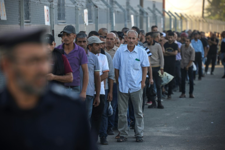 Palestinian labourers queue at the Gaza border to cross into Israel for work late last month. Under an always precarious truce between the two sides, Israel had eased its blockade in return for calm around the border