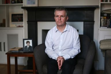 David Parfett sits next to a framed picture of his son Tom at his home in Maidenhead, United Kingdom, on September 22, 2023