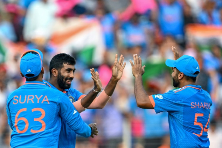 In the wickets: India's Jasprit Bumrah celebrates with teammates after taking the wicket of Pakistan's Mohammad Rizwan