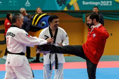 Chilean President Gabriel Boric (R) participates in a taekwondo demonstration