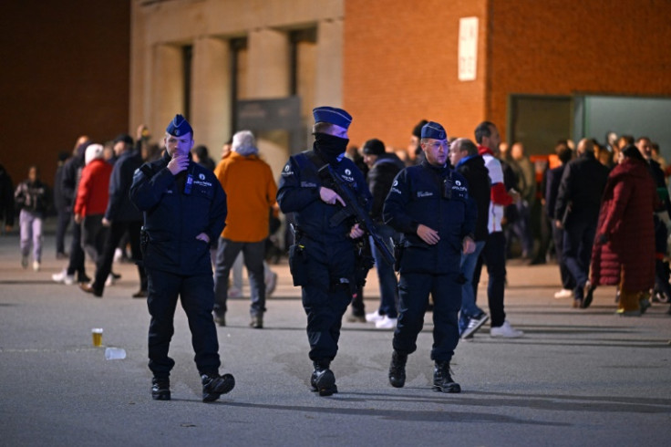 Police patrol as supporters leave the King Baudouin Stadium after the match was abandoned following the attack a few kilometres away