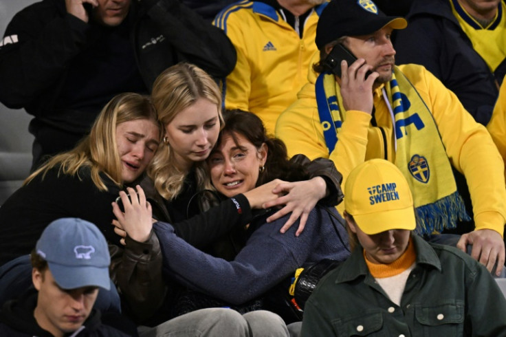 Sweden fans react after news of the attack. Spectators were held in the stadium for a few hours as a safety precaution, with Sweden fans escorted by police