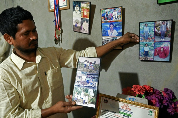 Bejhulal Dangaura shows portraits of his son Ashish Chaudhary