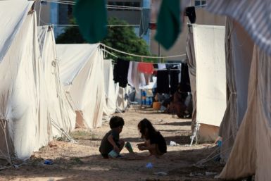 Children play among tents pitched on UN premises in Khan Yunis where their parents hope there may be some refuge from Israel's retaliatory bombardment of the Hamas-ruled Gaza Strip