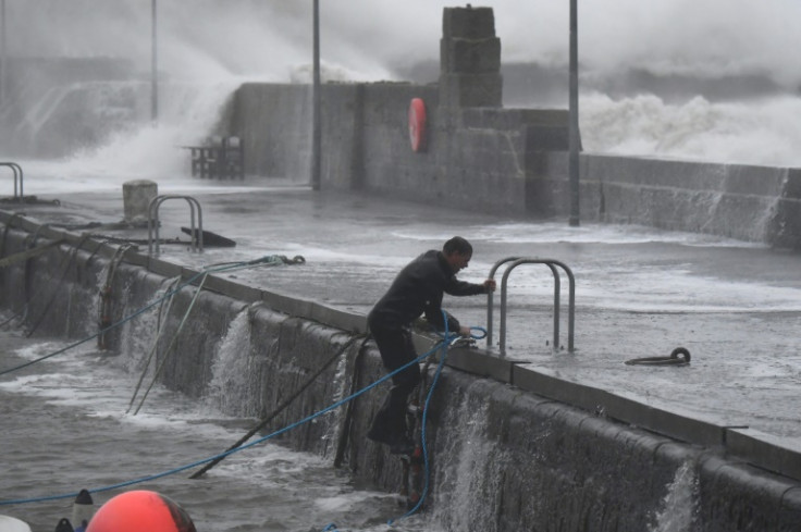 A boat owner braves conditions in Stonehaven harbour to secure boats on October 19