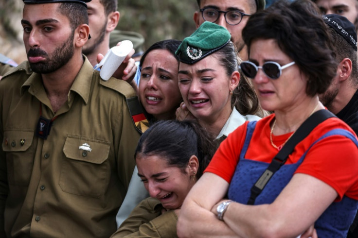 Comrades of French-Israeli soldier Eli Valentin Ghenassia, who was killed in combat at Kibbutz Beeri, mourn during his funeral in the Mount Herzl cemetery in Jerusalem on October 12, 2023