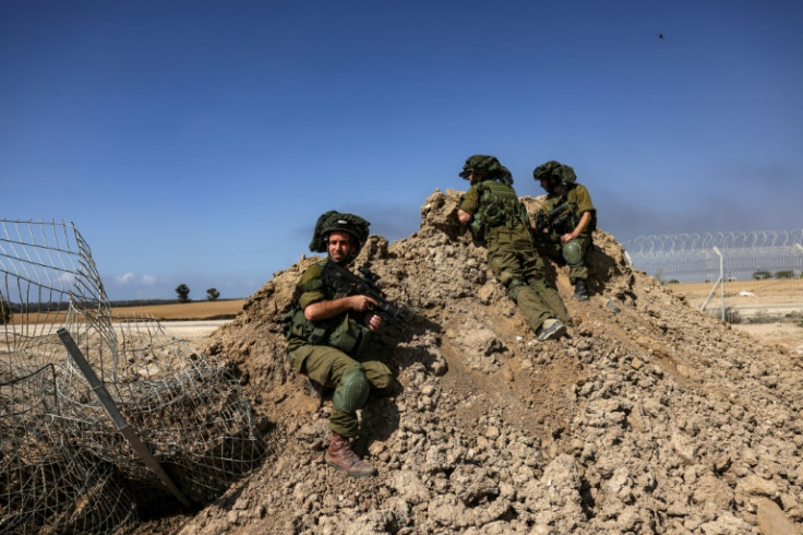 Israeli soldiers are positioned outside Kibbutz Beeri near the border with the Gaza Strip on October 20, 2023, amid the ongoing battles between Israel and the Palestinian group Hamas