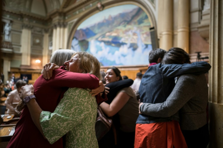 Members of the National Council embraced after sitting for the final time before the 2023 general election