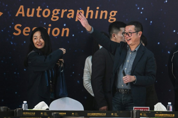 The global success of Chinese author Liu Cixin's (R) 'Three-Body' series catapulted its epic themes of technological prowess and the fate of humanity into the public consciousness