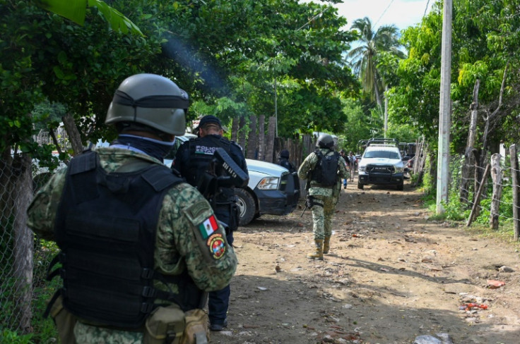 Security forces patrol the area where at least 11 police officers were killed in southern Mexico