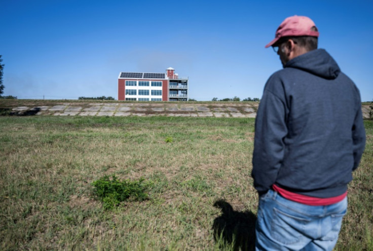 A Louisiana man looks at a grass-covered field that would normally be underwater; the Mississippi River has been at record low levels