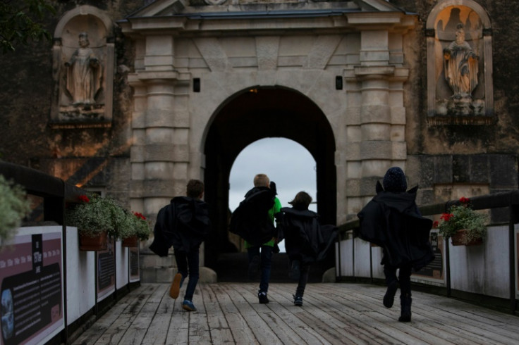 Children in Dracula costumes run through Forchtenstein Castle in Austria