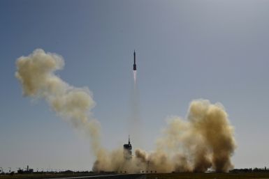 A Long March-2F carrier rocket, carrying the Shenzhou-17 spacecraft and a crew of three astronauts, is being prepared for lift off from the Jiuquan Satellite Launch Centre