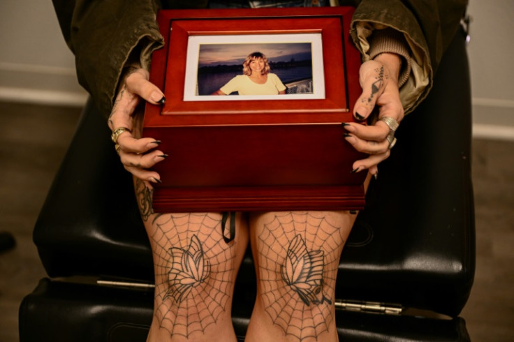 Scout Frank, seen here holding a box with the ashes of her cremated mother Theresa Pendleton, said she had wanted to keep her close