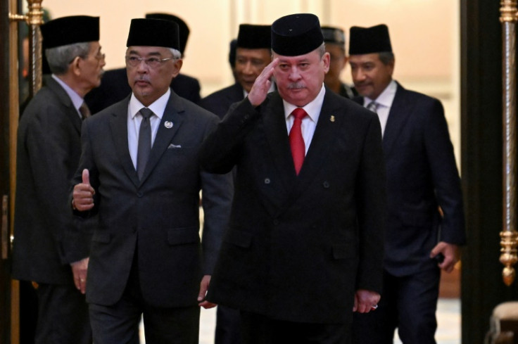 Malaysia's King Sultan Abdullah Sultan Ahmad Shah (2nd L) and Sultan Ibrahim Sultan Iskandar of Johor (2nd R) walk together after the election for the next Malaysian king