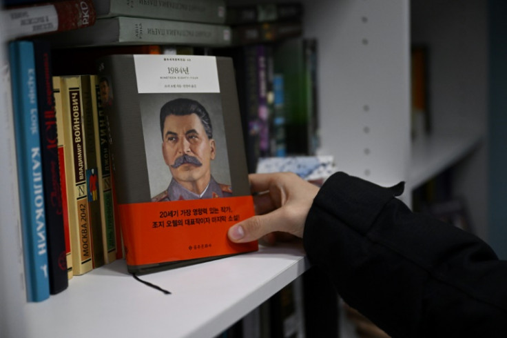 The library's shelves include a South Korean edition of Orwell's "1984", with a portrait of Stalin on the cover