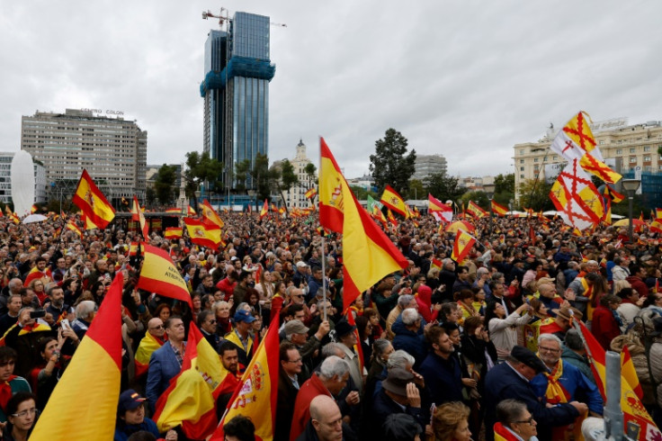 Protestors wave Spanish flags at a Madrid protest against plans to grant an amnesty to Catalan separatists