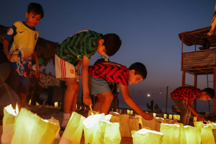 Last week, children light candles at a vigil in memory of Lebanese Journalist Issam Abdallah and in support of Palestinians