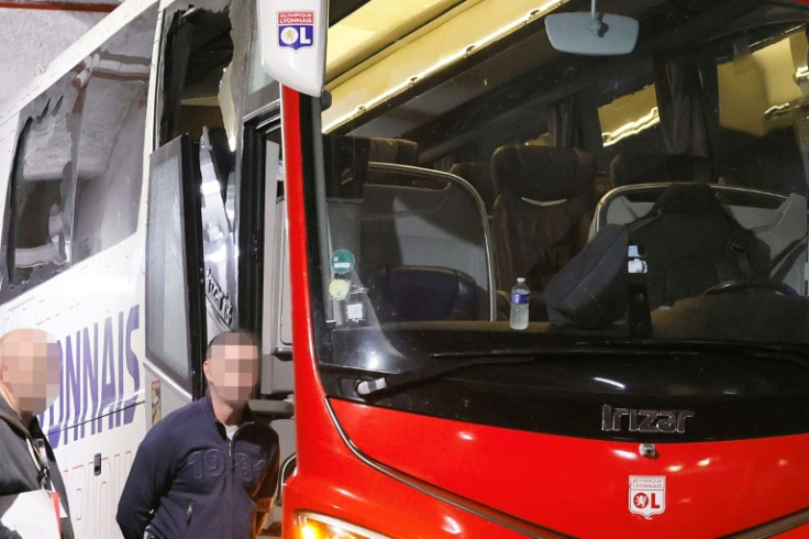 The smashed window of Lyon's team bus is visible after stones were thrown as it travelled to Marseille's Velodrome stadium