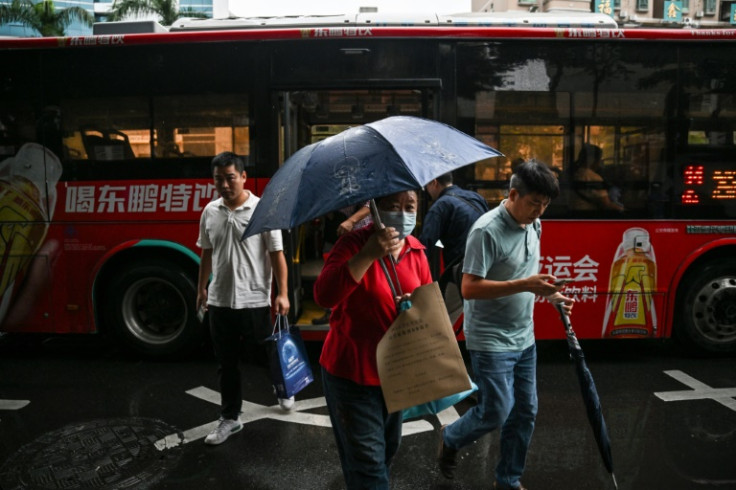 On a rainy afternoon in Shenzhen, damp passengers jostle their way onto the megacity's buses, the quiet foot soldiers of an electric revolution