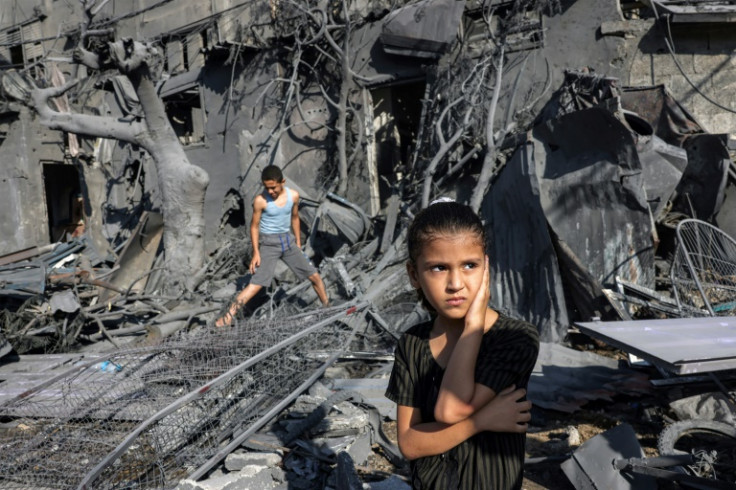 A girl amid the rubble of a building hit by Israeli bombardment in Rafah in the southern Gaza Strip