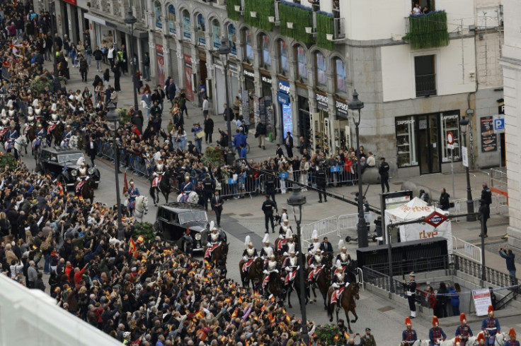 Flag-waving, cheering crowds watched the brief ceremony live on giant screens set up around Madrid