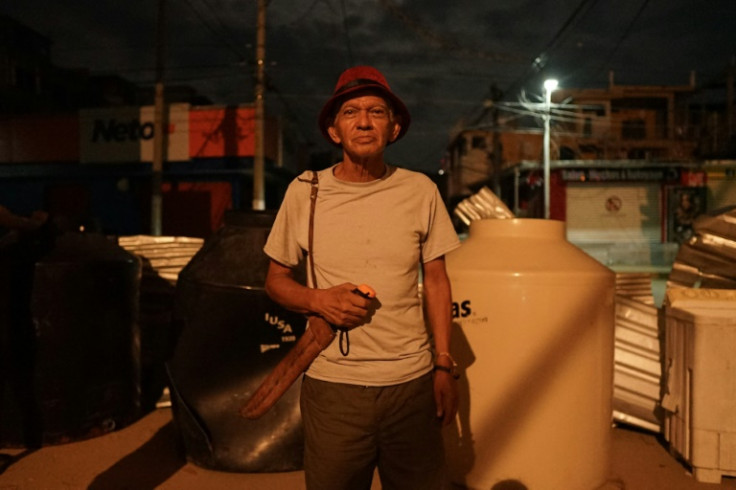 A resident armed with a machete guards a neighborhood against looters in Mexico's hurricane-hit city of Acapulco