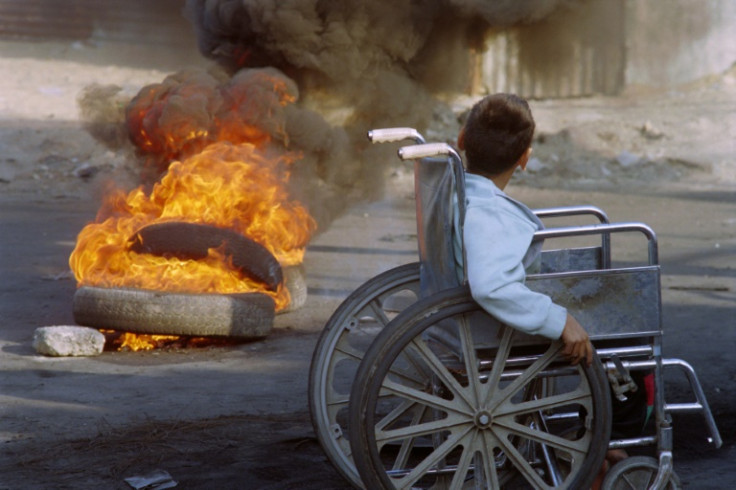 A young boy in a wheelchair moves around the Jabaliya refugee camp in Gaza