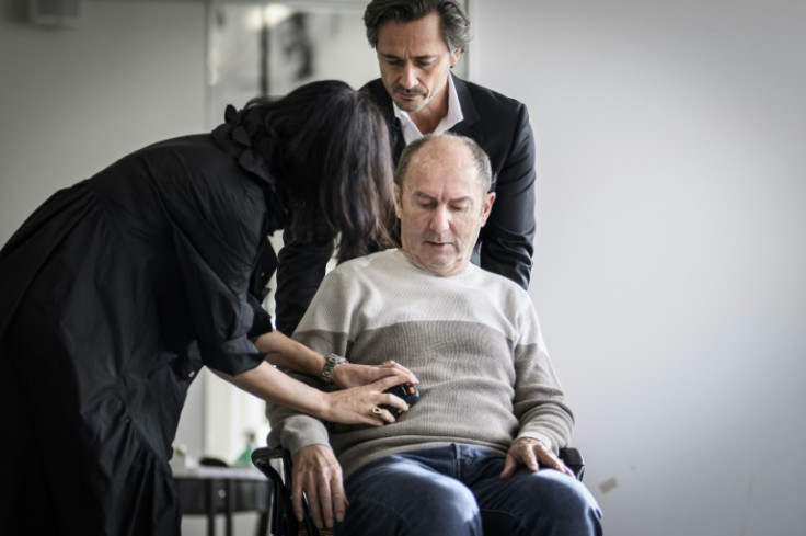 Surgeon Jocelyne Bloch and neuroscientist Gregoire Courtine switch on Marc's neuroprosthesis