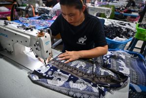 A worker assembles elephant print clothing at the Chinrada Garment factory in northern Thailand's Chiang Mai