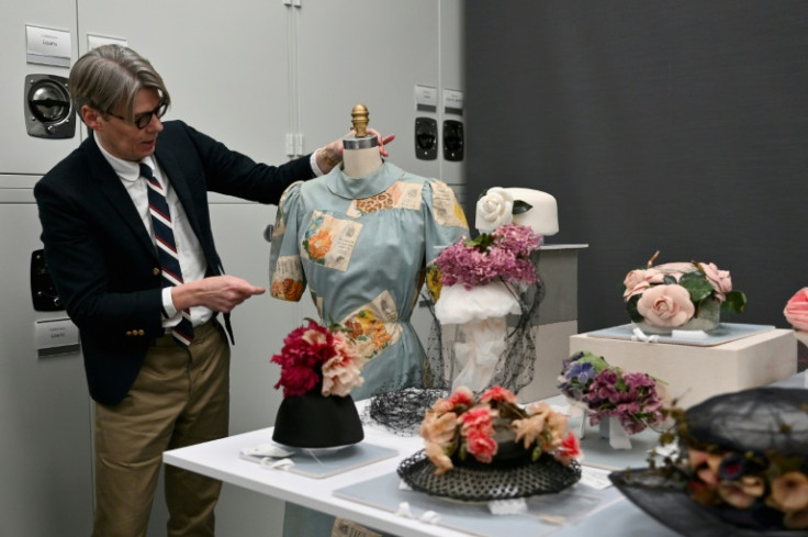 Costume Institute curator Andrew Bolton shows a Schiaparelli dress from 1939-1941 to the press