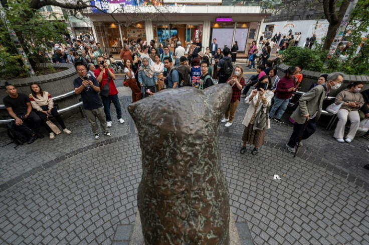 People snap photos of the statue of 'Hachiko', the loyal dog who went to Shibuya station every day for 10 years awaiting the return of his dead master