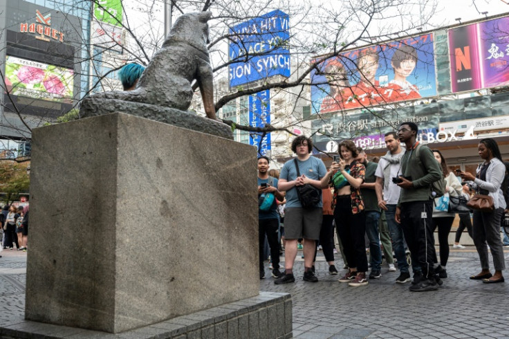 People queue up to pose for photos with the statue of 'Hachiko', whose tale inspired a 2009 movie starring Richard Gere