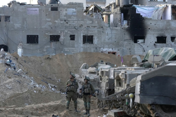 --PHOTO TAKEN DURING A CONTROLLED TOUR AND SUBSEQUENTLY EDITED UNDER THE SUPERVISION OF THE ISRAELI MILITARY— Israeli troops are pictured during operations in northern Gaza on November 8, 2023, amid continuing battles between Israel and the Palestinian mi