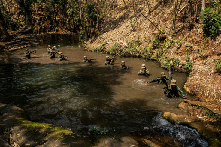 Members of the ethnic rebel group Ta'ang National Liberation Army (TNLA) take part in a training exercise at their base camp in the forest in Myanmar's northern Shan State in March 2023