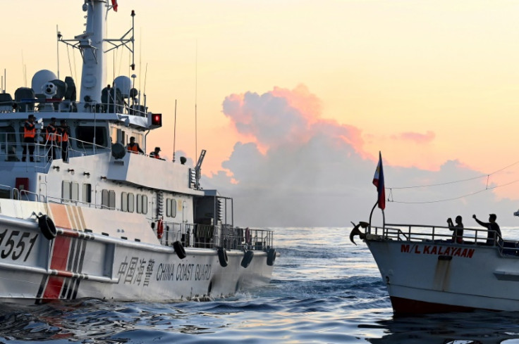 A Chinese Coast Guard vessel (L) blocks a chartered supply boat on a mission to deliver provisions to a grounded Philippine Navy vessel at Second Thomas Shoal in the South China Sea