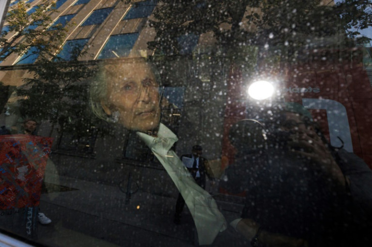 Seen through a police vehicle window, Canadian-Finnish fashion mogul Peter Nygard leaves a courthouse in Toronto