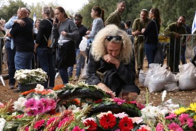 Israeli soldiers and civilians attend the funeral of Matan Meir, a producer of the Netflix series 'Fauda' who was killed in combat while on reserve duty for the army during its war with Hamas